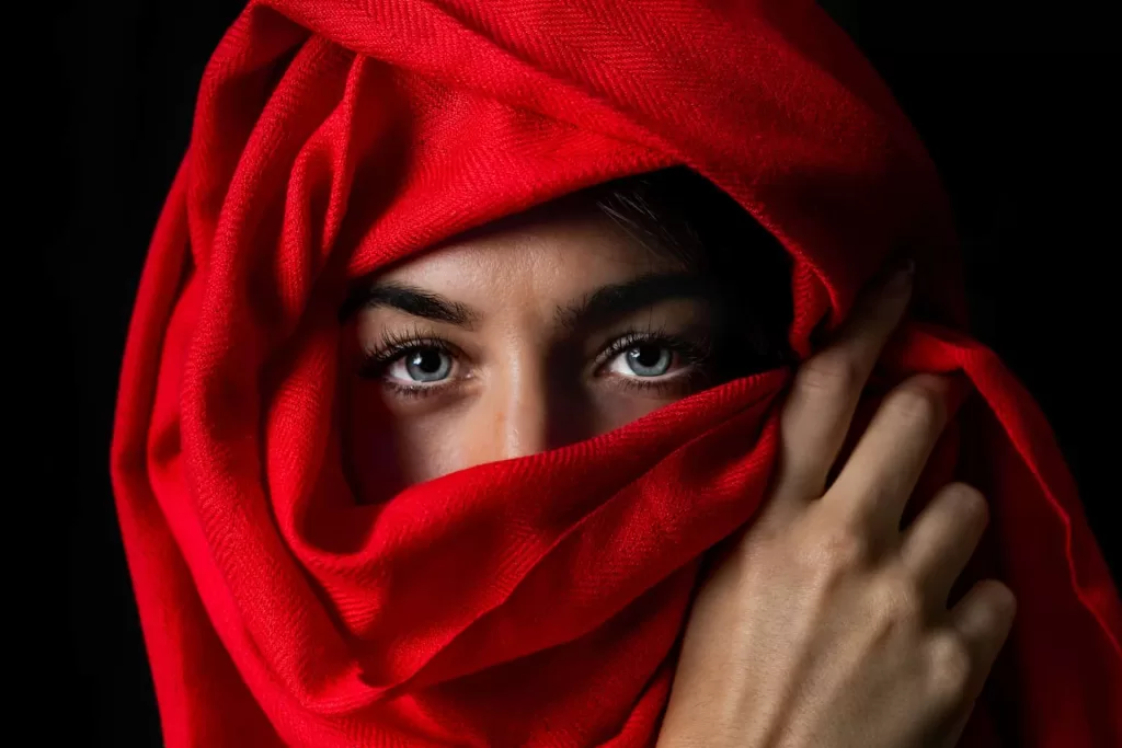 Arab Woman with blue eyes Wearing a red Niqab